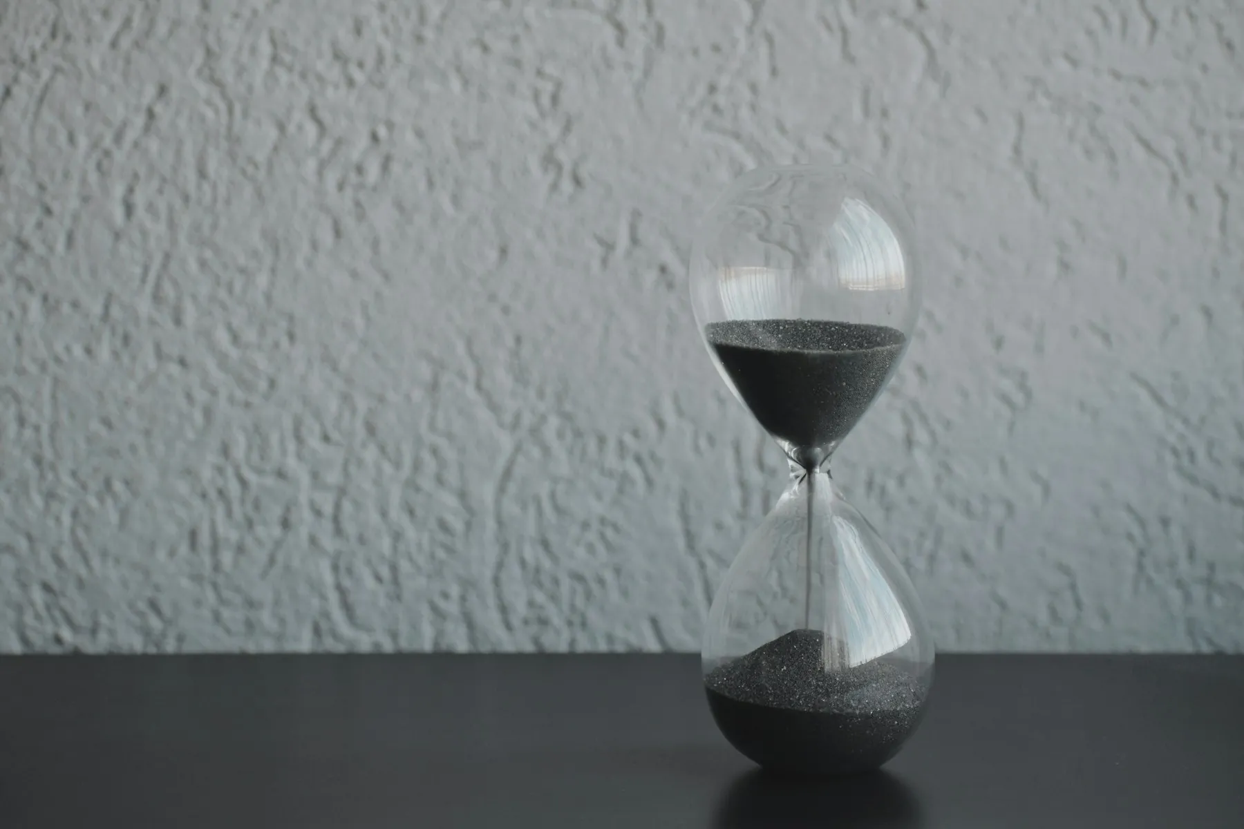 Sanduhr vor weißer Wand